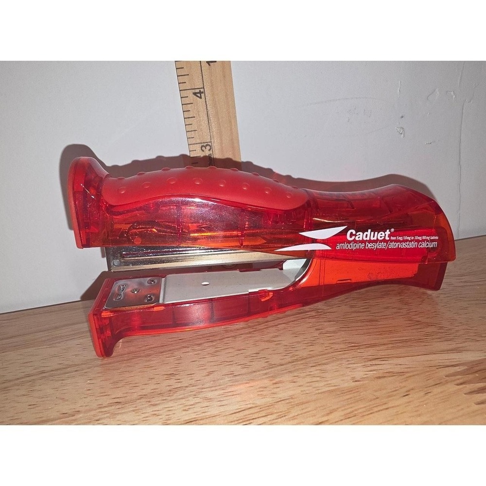 red translucent office stapler imprinted with drug branding for Caduet